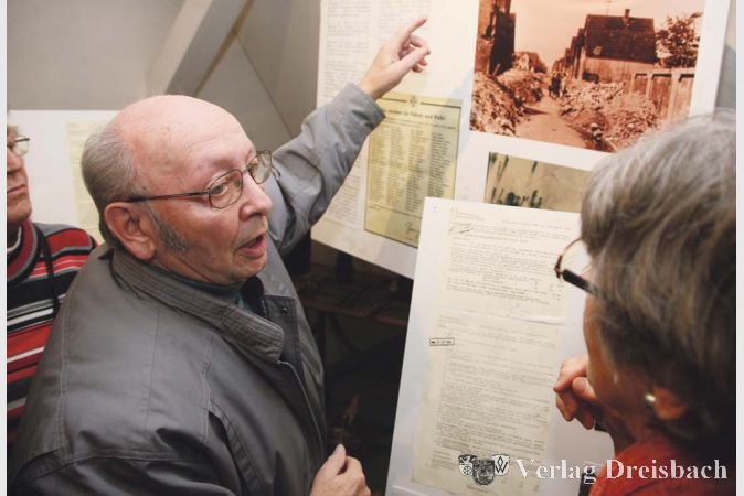 Zeitzeuge Wilfried Becker erkennt auf dem Foto der zerst&ouml;rten Rheinstra&szlig;e die H&auml;user der Nachbarschaft. Er selbst wurde in der N&auml;he versch&uuml;ttet und &uuml;berlebte den Angriff mit seinen Geschwistern aber.?(gus/Fotos: Steinacker)

&nbsp;