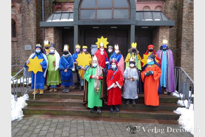 Aufbruch der Sternsinger vor dem Portal von St. Vitus im leicht verschneiten Kriftel.