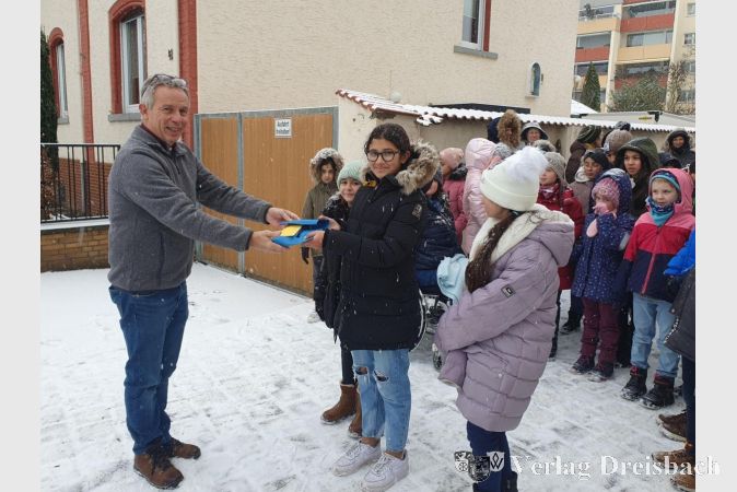 Klaus Störch stand die Freude über die Spende der Regenbogenschüler*Innen an das Haus Sankt Martin bei der Scheckübergabe im Schneegestöber ins Gesicht geschrieben.