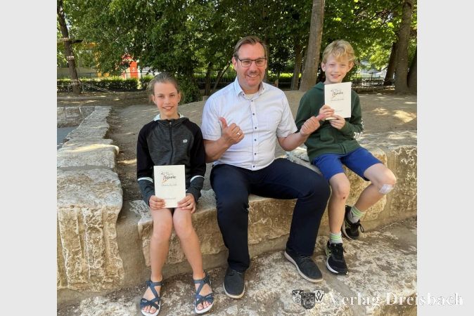 Jana Gieseke und Philipp Claussen – die Schulbeste/der Schulbeste bei den Bundesjugendspielen 2023 – mit Bürgermeister Seitz auf dem Schulhof.