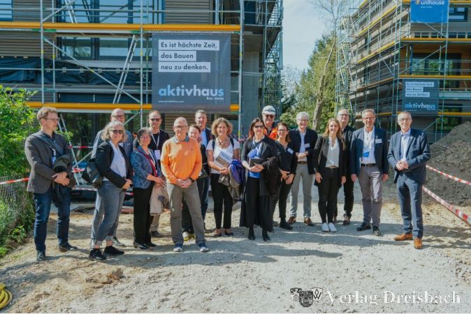 Expertengruppe vor dem Bauprojekt in der Raiffeisenstraße im Rahmen des GFB-Bausymposiums im Mai.
